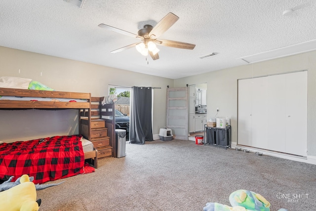 bedroom featuring ceiling fan and a textured ceiling