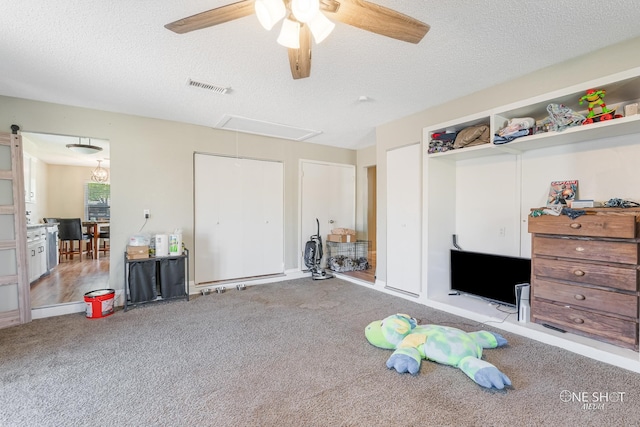 misc room with light carpet, a textured ceiling, and ceiling fan