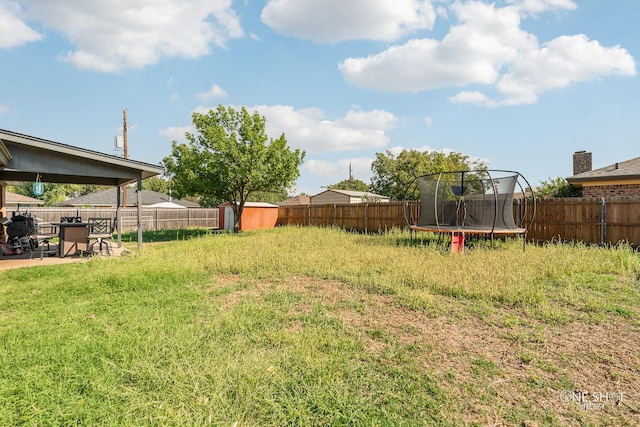 view of yard with a patio area and a trampoline