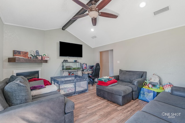 living room featuring vaulted ceiling with beams, hardwood / wood-style flooring, ceiling fan, and crown molding