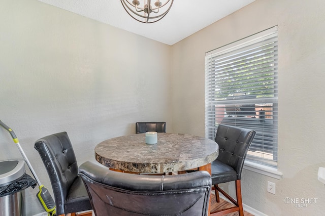 dining room featuring hardwood / wood-style flooring and a notable chandelier