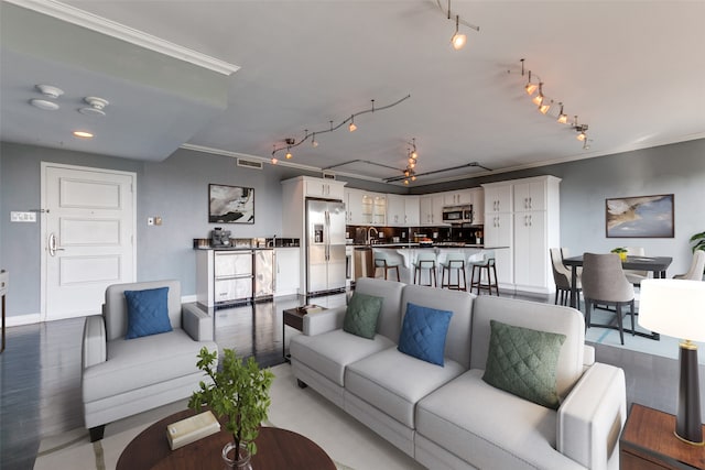 living room with ornamental molding, hardwood / wood-style flooring, and rail lighting