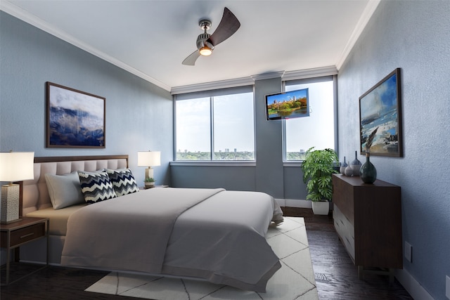 bedroom featuring crown molding, dark wood-type flooring, and ceiling fan