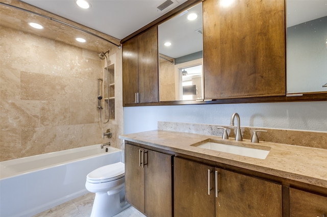 full bathroom with toilet, tiled shower / bath, and vanity