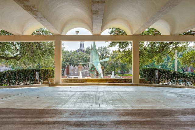 unfurnished sunroom with vaulted ceiling with beams