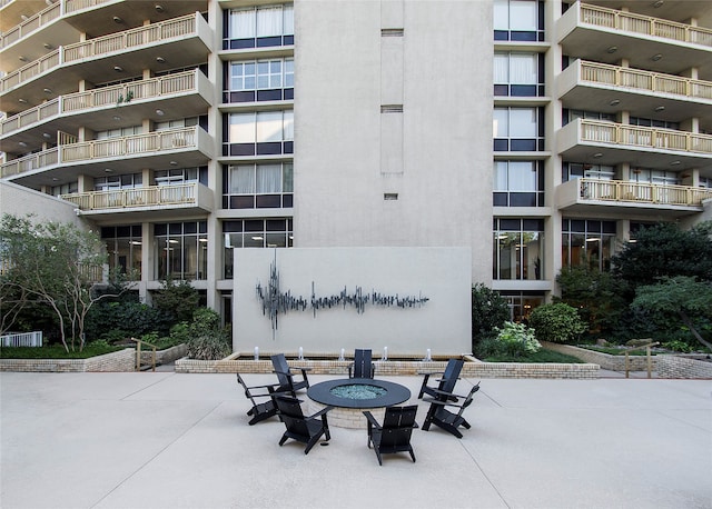 view of building exterior featuring an outdoor fire pit