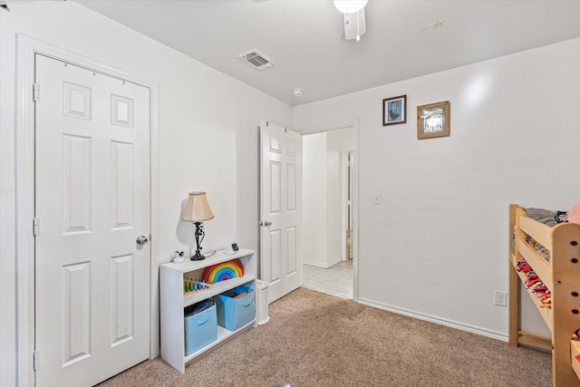 playroom featuring light carpet and ceiling fan