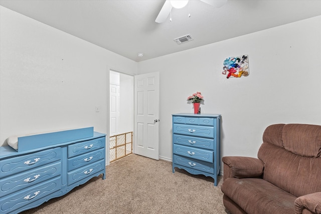 living area with ceiling fan and light carpet