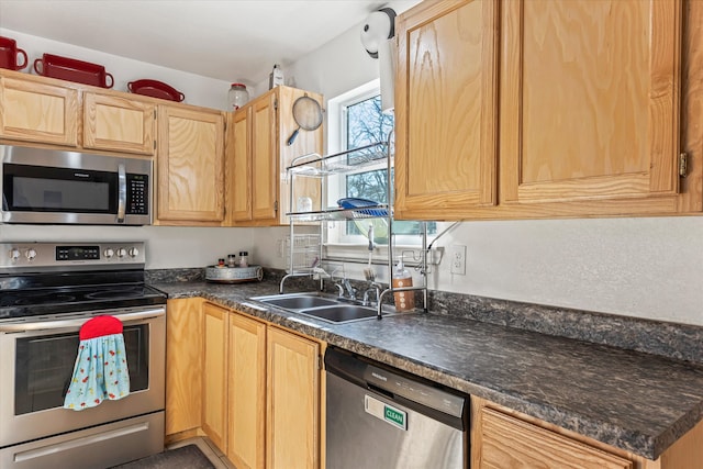 kitchen featuring light brown cabinetry, sink, and appliances with stainless steel finishes