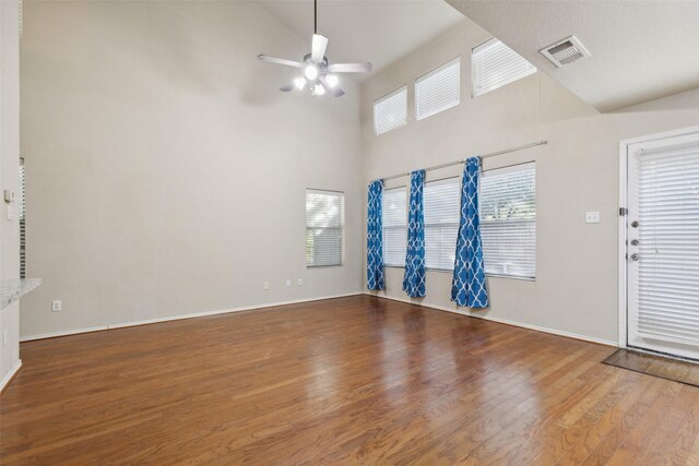 dining area with a high ceiling, light hardwood / wood-style floors, and ceiling fan