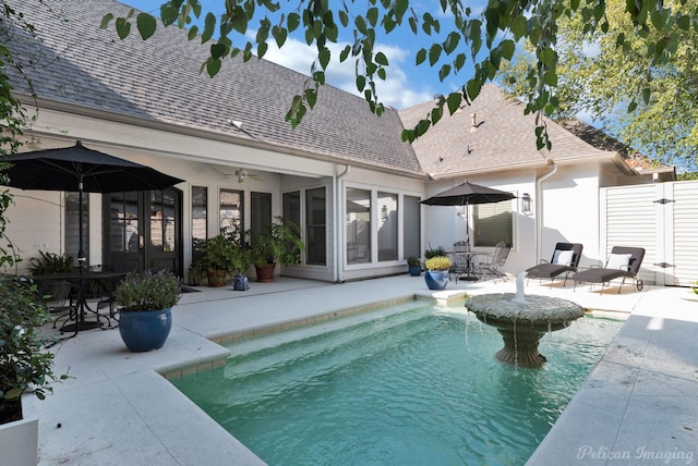 rear view of property with ceiling fan and a patio