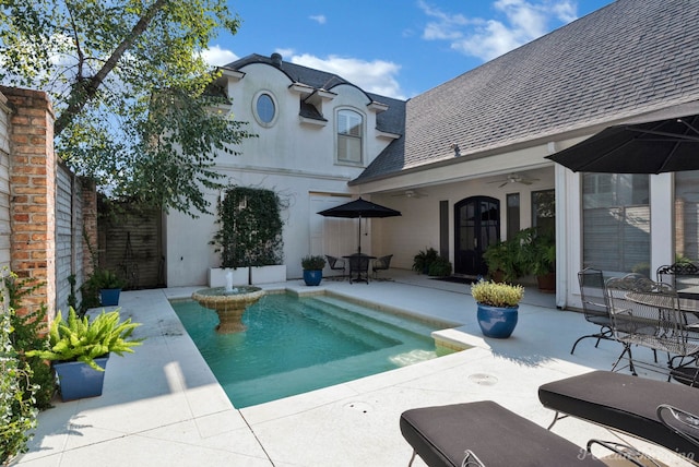 view of swimming pool with ceiling fan and a patio