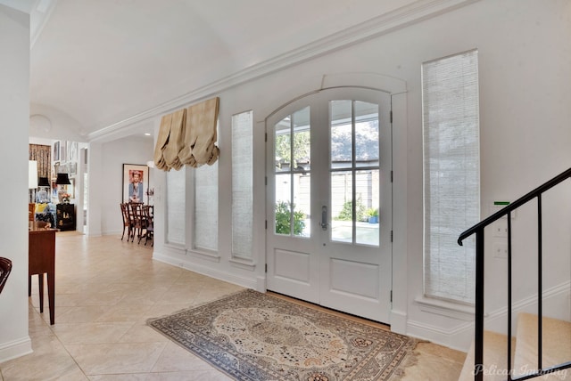 foyer entrance featuring lofted ceiling and light tile patterned floors