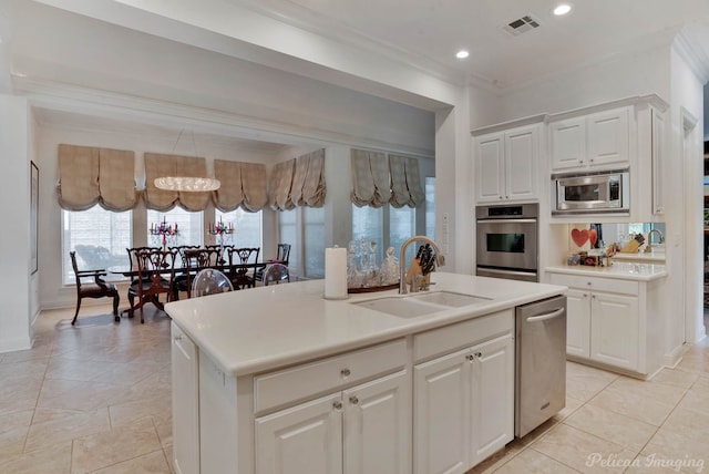 2 Beaux Rivages Dr, Shreveport, LA 71106 - kitchen with crown molding, a sink, appliances with stainless steel finishes, light countertops, and an island with sink