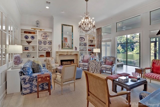 living room featuring built in shelves, ornamental molding, and a chandelier