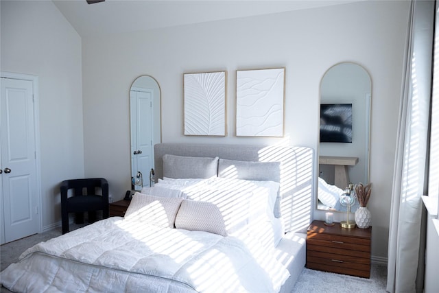 carpeted bedroom featuring vaulted ceiling