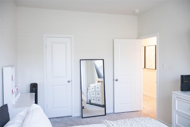 bedroom featuring light carpet