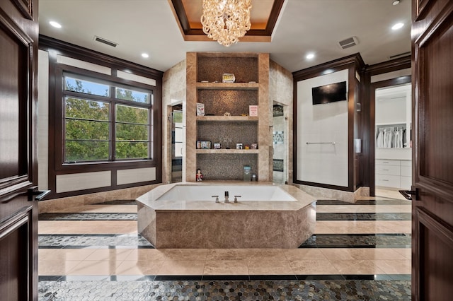 bathroom with ornamental molding, tiled tub, and a chandelier