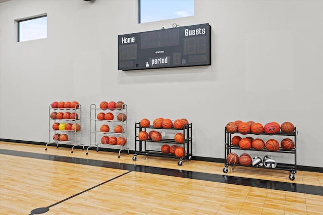 exercise area with a towering ceiling and wood-type flooring