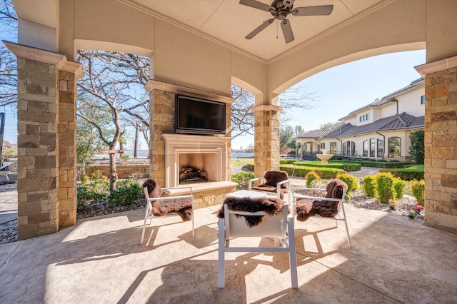 view of patio featuring ceiling fan and an outdoor stone fireplace