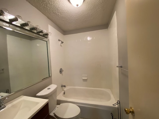 full bathroom with toilet, tiled shower / bath combo, vanity, and a textured ceiling