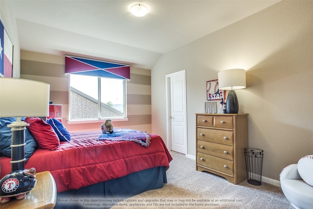 carpeted bedroom with vaulted ceiling