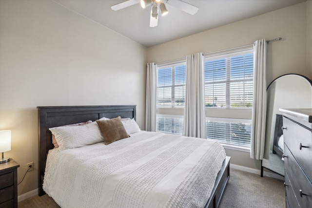 bedroom with dark colored carpet and ceiling fan