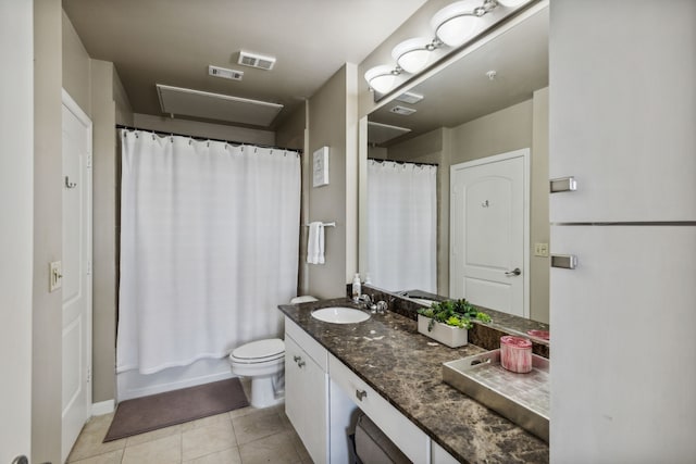 bathroom with vanity, tile patterned flooring, and toilet