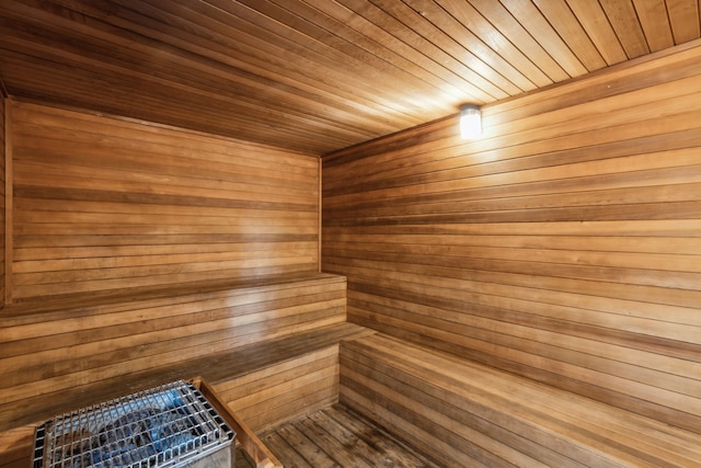 view of sauna / steam room featuring wood walls and wooden ceiling