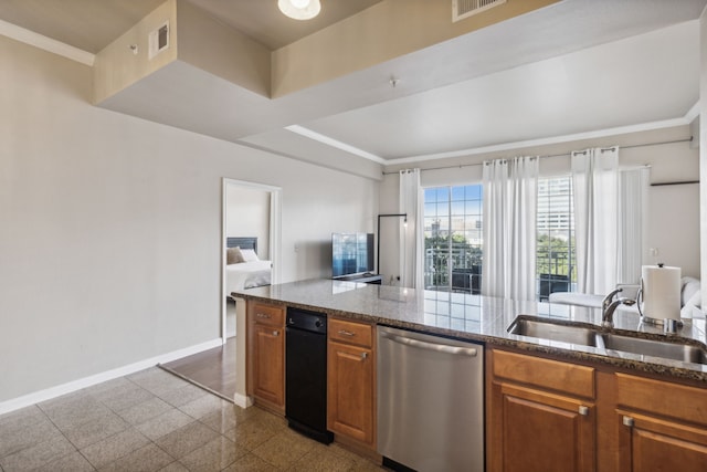 kitchen with dark stone countertops, crown molding, sink, and stainless steel dishwasher