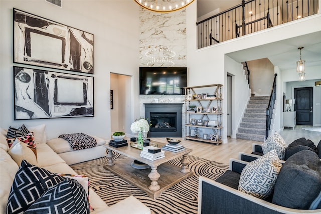 living room with light hardwood / wood-style floors and a high ceiling