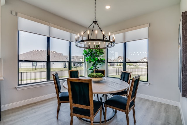 dining space with a notable chandelier and light wood-type flooring