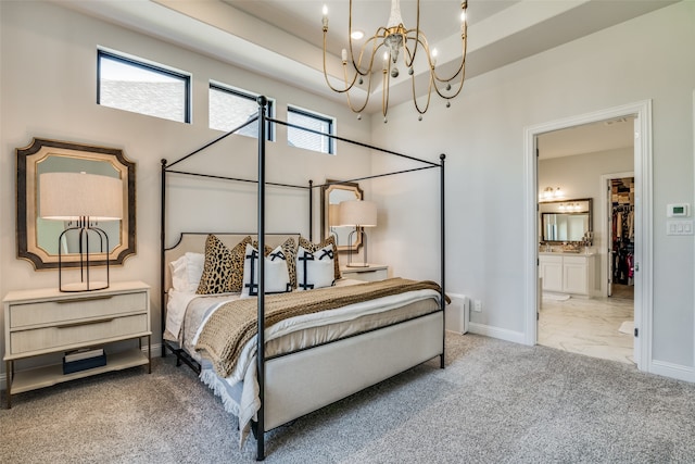 carpeted bedroom with multiple windows, ensuite bath, and an inviting chandelier