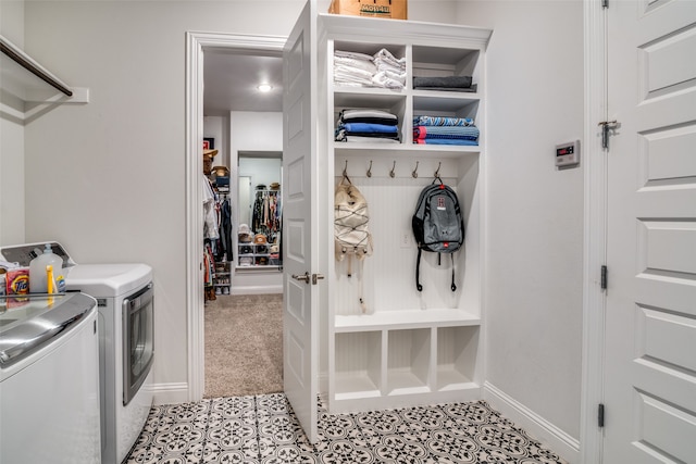 washroom featuring light tile patterned floors and washing machine and clothes dryer