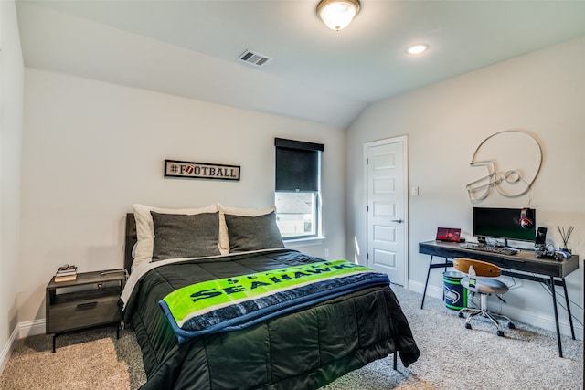 bedroom with vaulted ceiling and light colored carpet