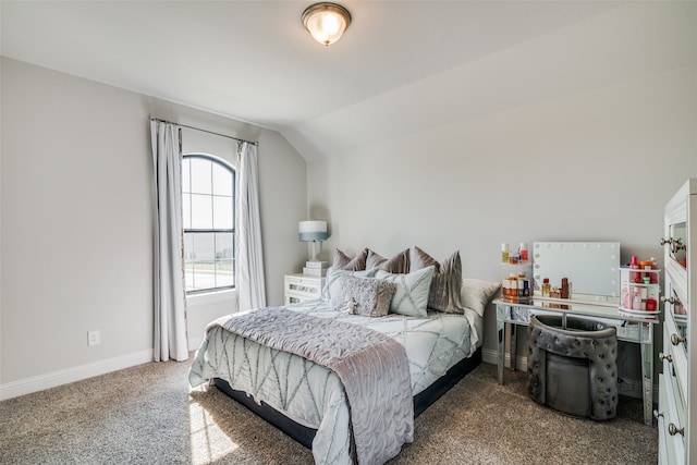 bedroom featuring lofted ceiling and carpet