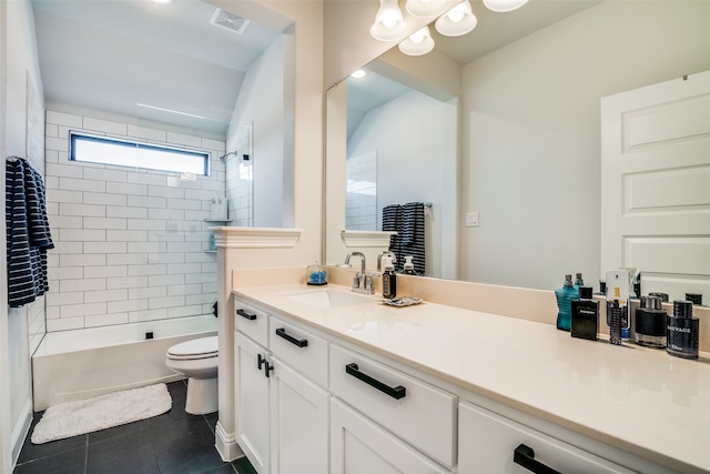 full bathroom featuring tiled shower / bath, vanity, tile patterned flooring, and toilet