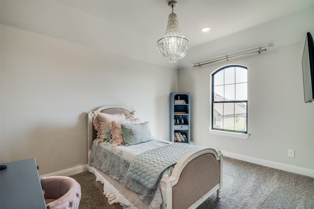 carpeted bedroom featuring an inviting chandelier