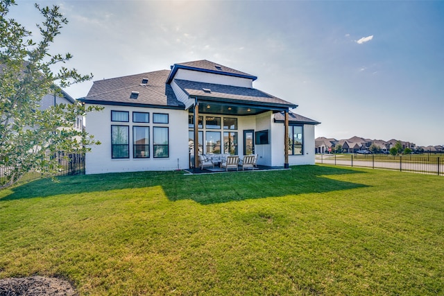 back of house featuring a lawn and a patio area