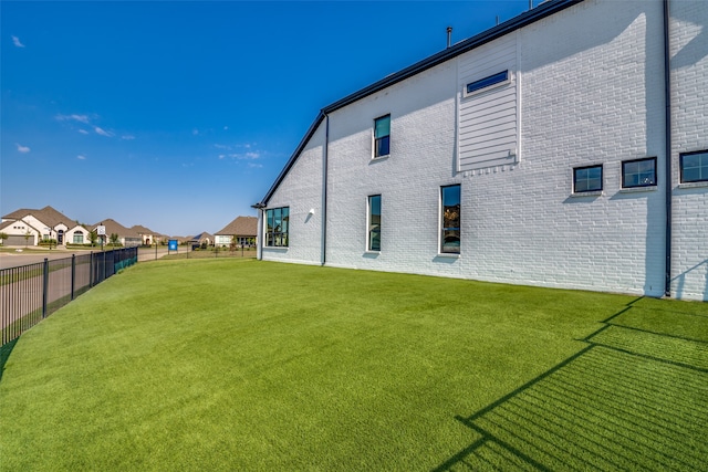 rear view of property with a lawn