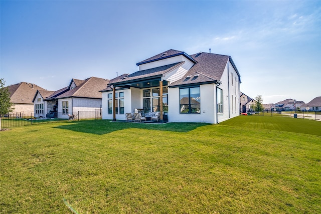 back of house featuring a yard and a patio area