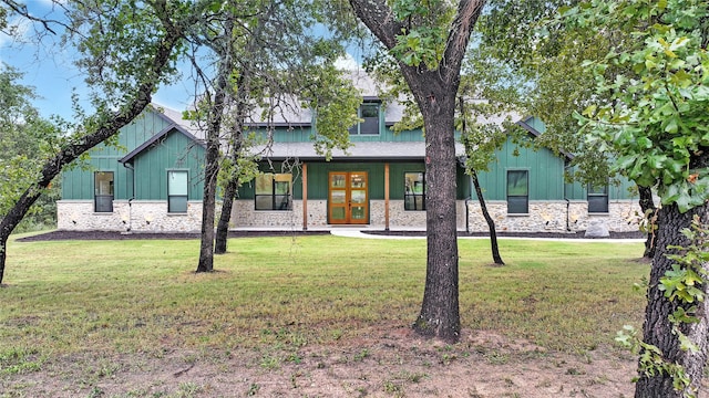 view of front facade featuring french doors and a front lawn