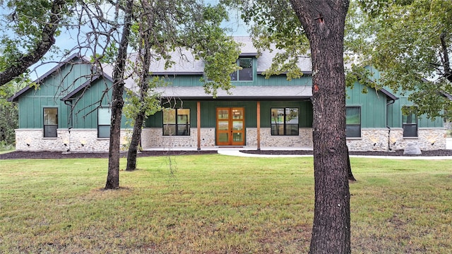 craftsman-style house featuring french doors and a front yard