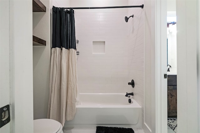 bathroom with shower / tub combo and toilet