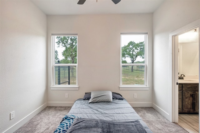 carpeted bedroom featuring ceiling fan, sink, and connected bathroom