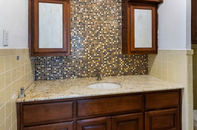 bathroom featuring backsplash, vanity, and toilet