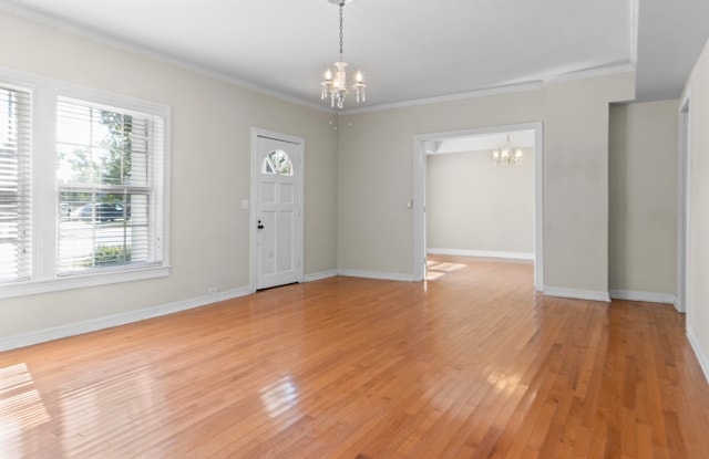 interior space with an inviting chandelier, light wood-type flooring, and crown molding