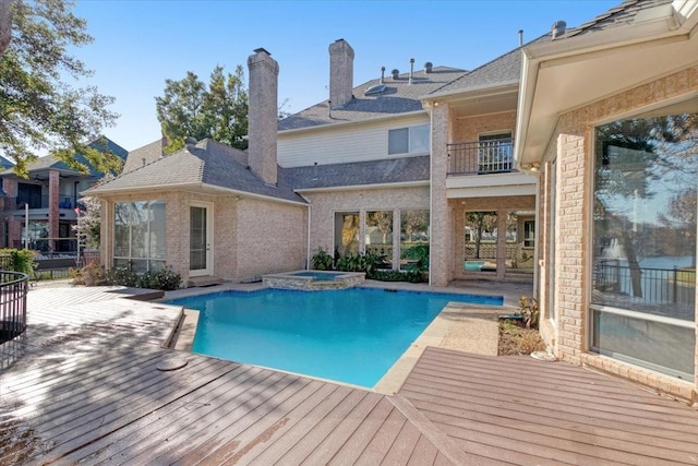 view of swimming pool with an in ground hot tub and a patio area