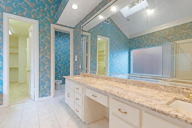 bathroom featuring a bidet, vanity, crown molding, and a skylight