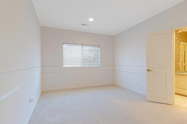 unfurnished room with light carpet and crown molding